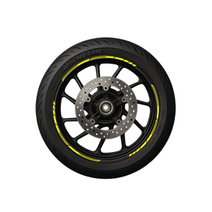A black motorcycle wheel with yellow pre-curved decals on the rim, designed to create a stripe effect.