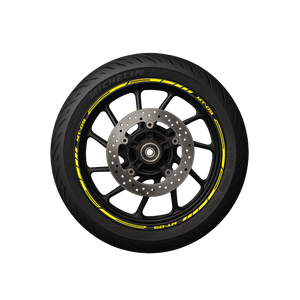 A black motorcycle wheel with yellow pre-curved decals on the rim, designed to create a striped pattern.